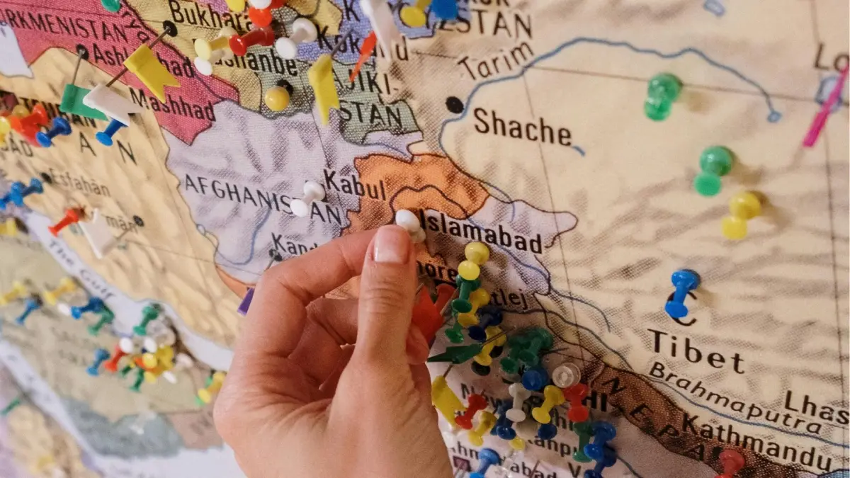 Una mano sitúa unas marcaciones en un mapa de Medio Oriente