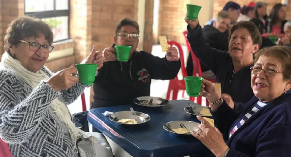 Personas tomando el desayuno en un Centro de Cuidado Transitorio Día/Noche